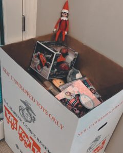 top 5 new year's eve decorations elf sitting next to toys for tots