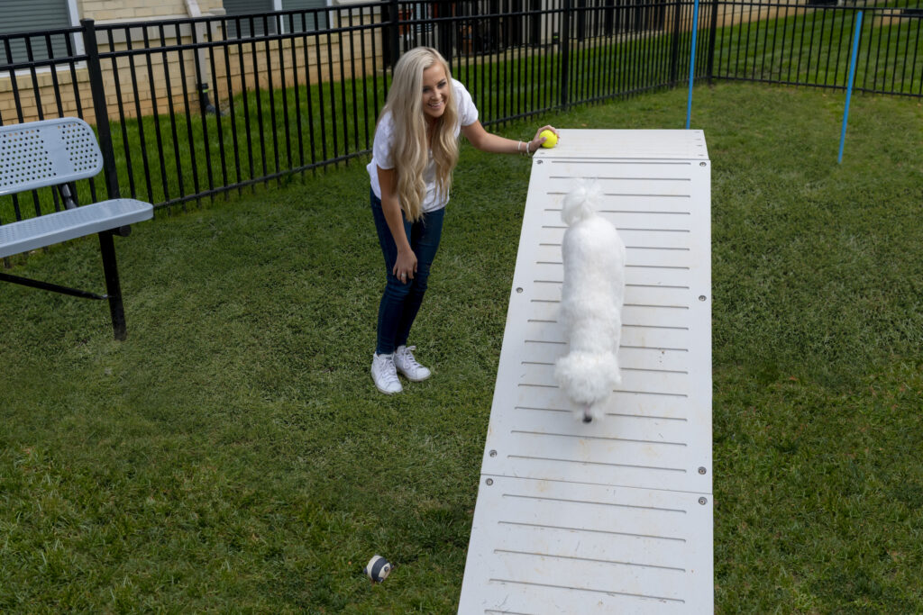 girl with dog at dog park