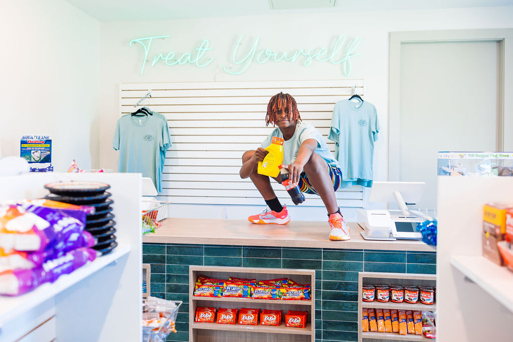 boy smiling on the counter of clubhouse store