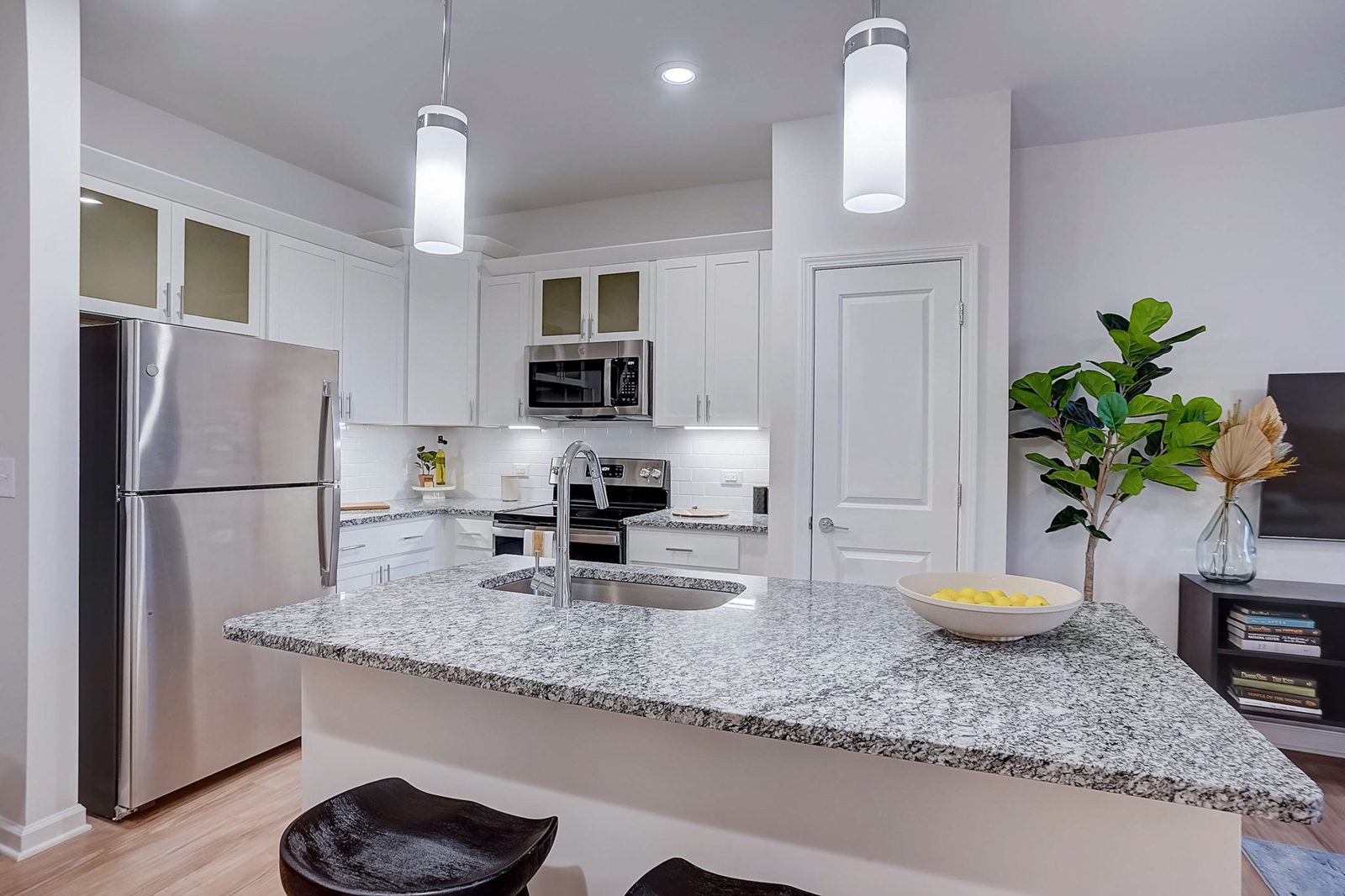 Evolve Lake Norman open kitchen with quartz counters and white cabinets