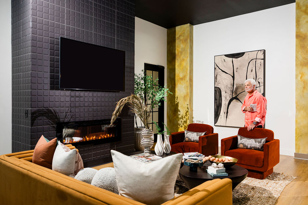 man standing in front of fireplace in resident clubhouse at Evolve Waterford