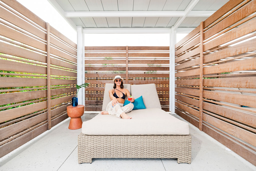 woman laying on bed in cabana at the pool at Evolve Waterford