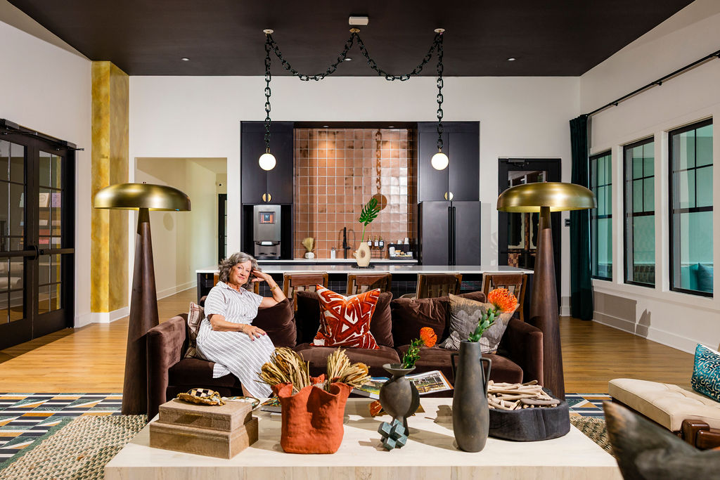 woman smiling on the couch in the resident clubhouse at Evolve Waterford