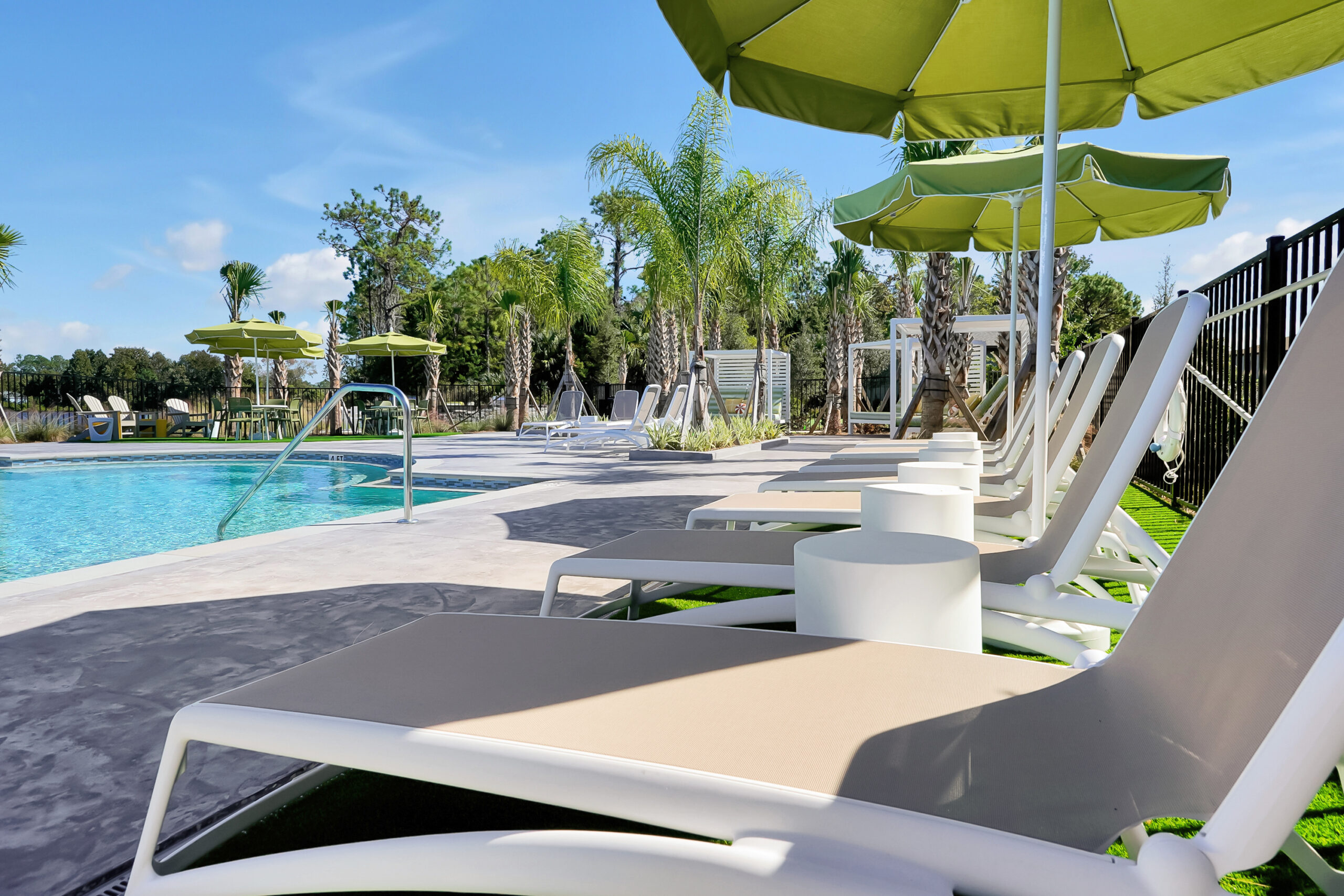 Evolve Palm Coast pool with lounge chairs and umbrellas