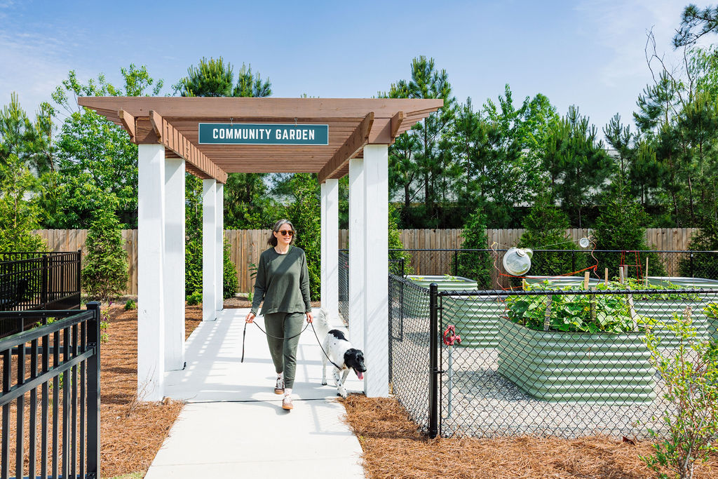 woman walking dog in community garden at Evolve Waterford